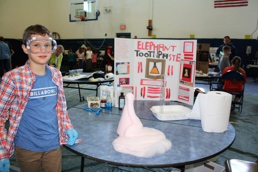 student with display on toothpaste