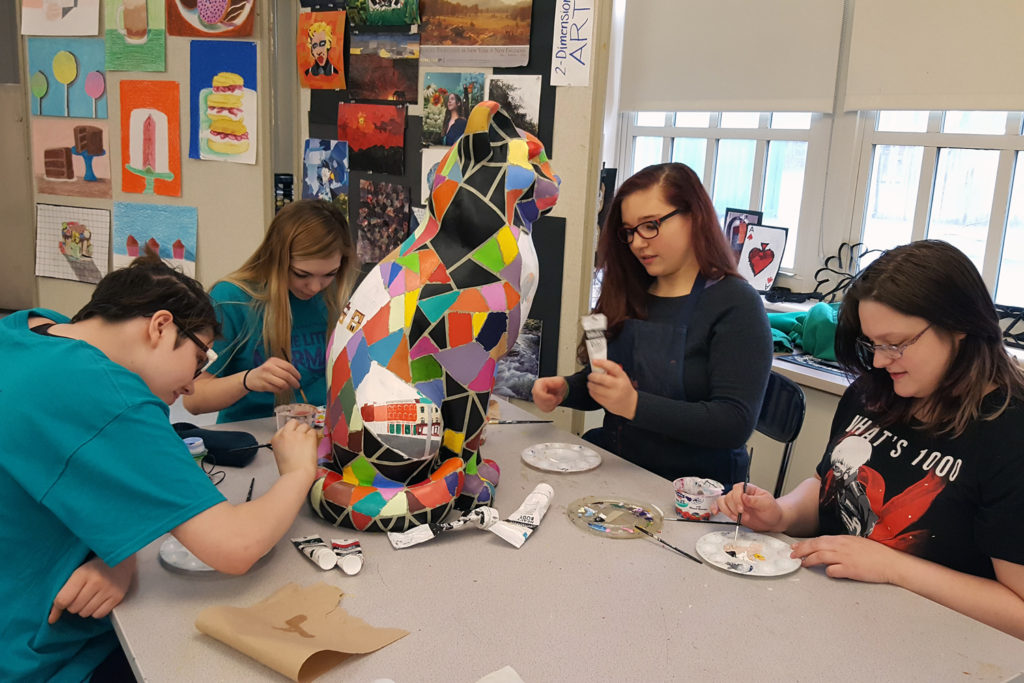students painting cat