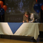 student signing