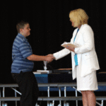 student shakes hands with Mrs. Schlenker