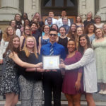 Concert Chorus with their Gold certificate on the steps of Kingston High School