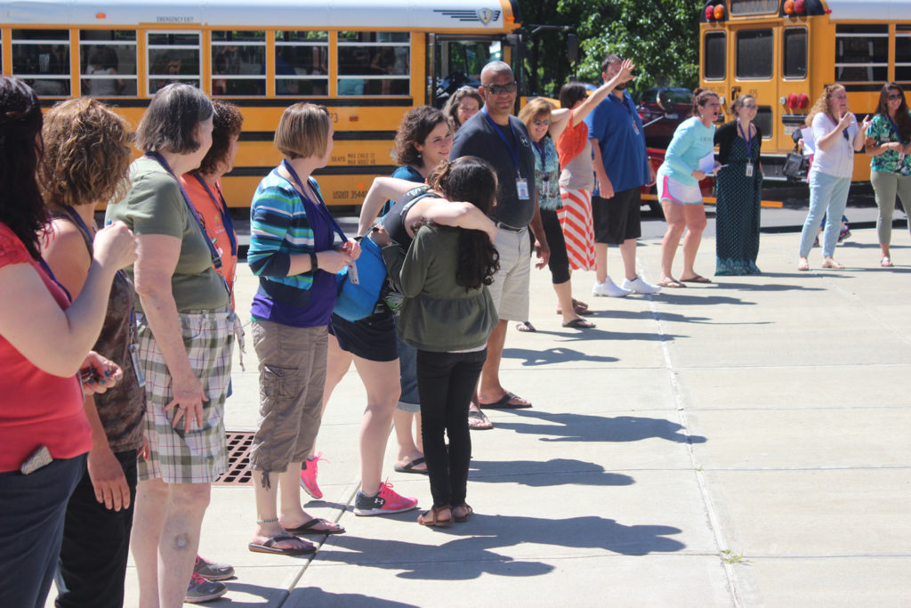CMS staff wave and give out hugs as students leave for summer break