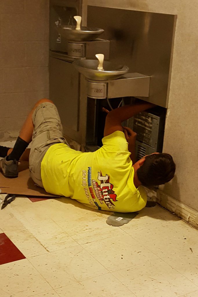 Plumber working on water fountain