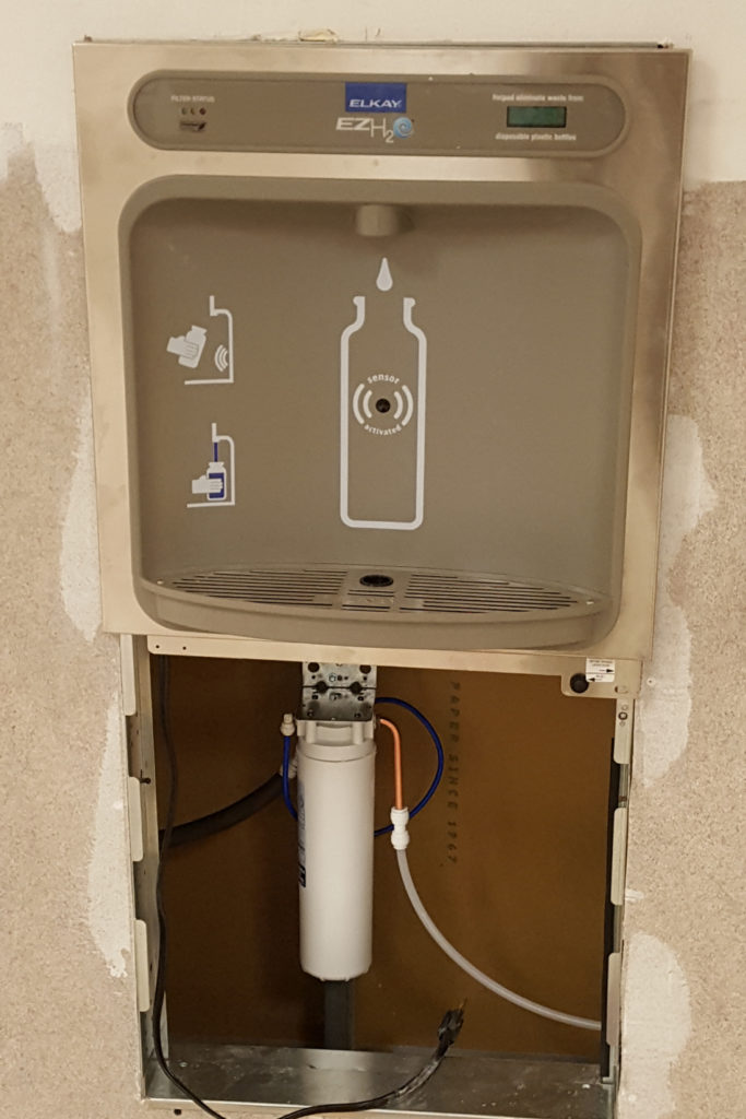 water bottle filler station shown partly installed in wall