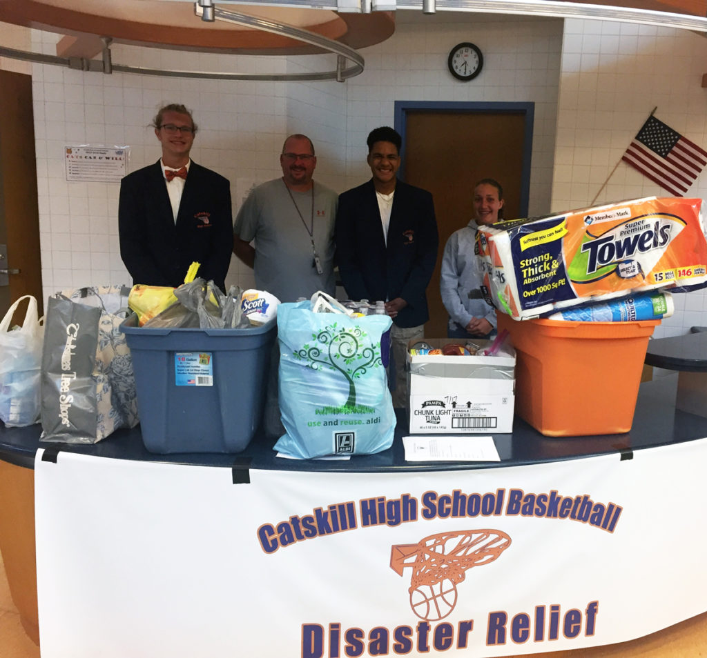William Bartholomew, Coach Doug Lampman, Justice Brantley and Ashley Shook with items they collected.