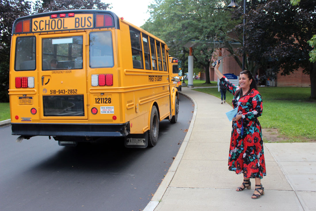 High School pricipal wave to busses