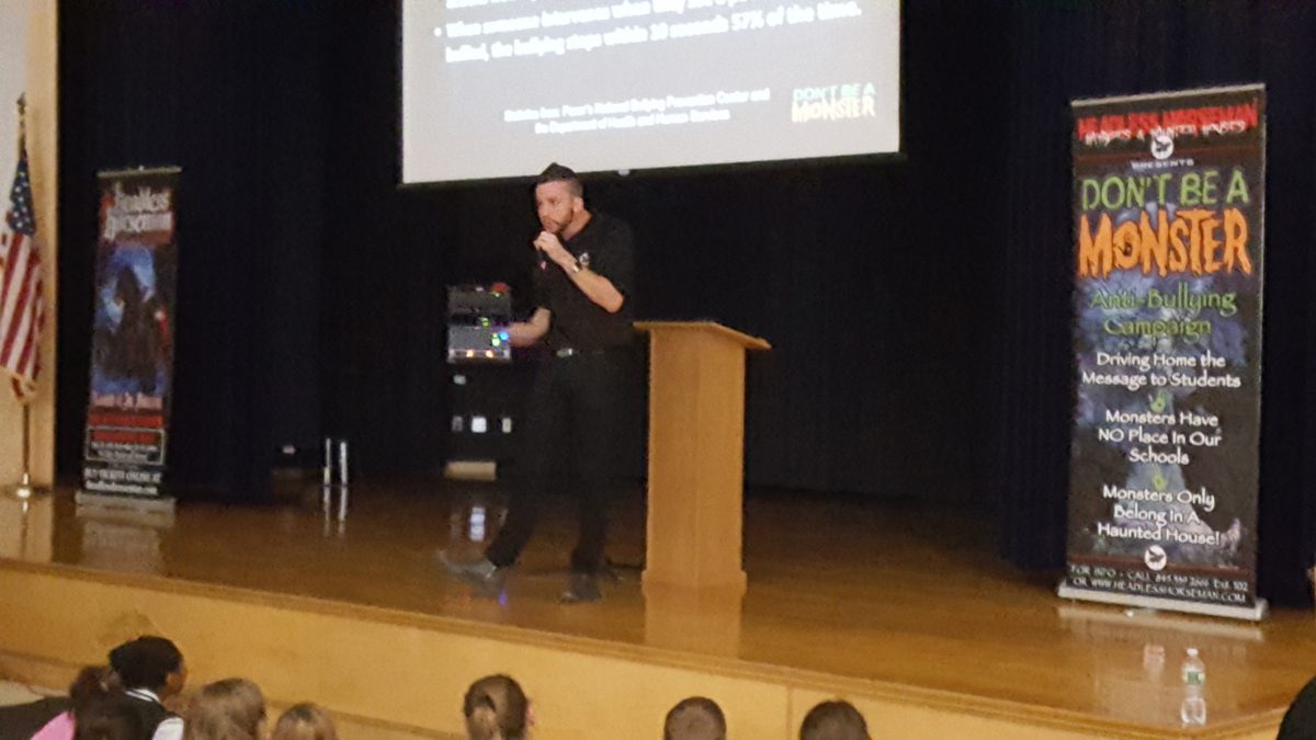 illusionist performs for students