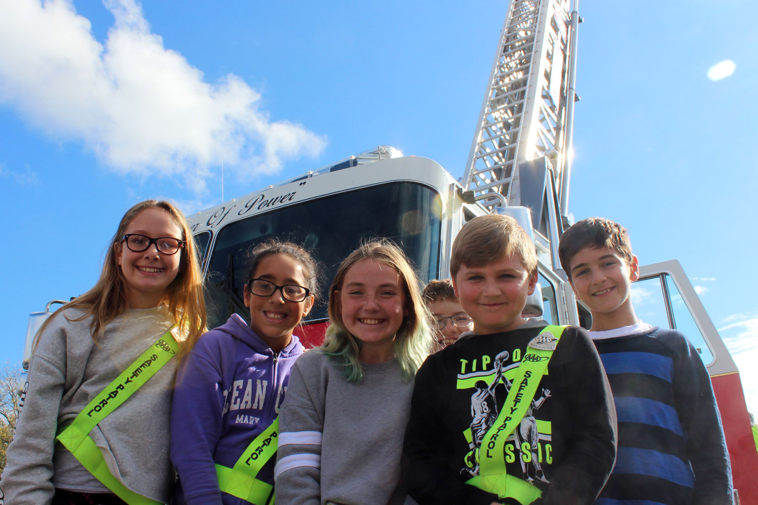 safety patrol poses infront of the ladder truck