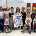 Pre-K students pose with sign that says thanks you BOE from the class of 2031