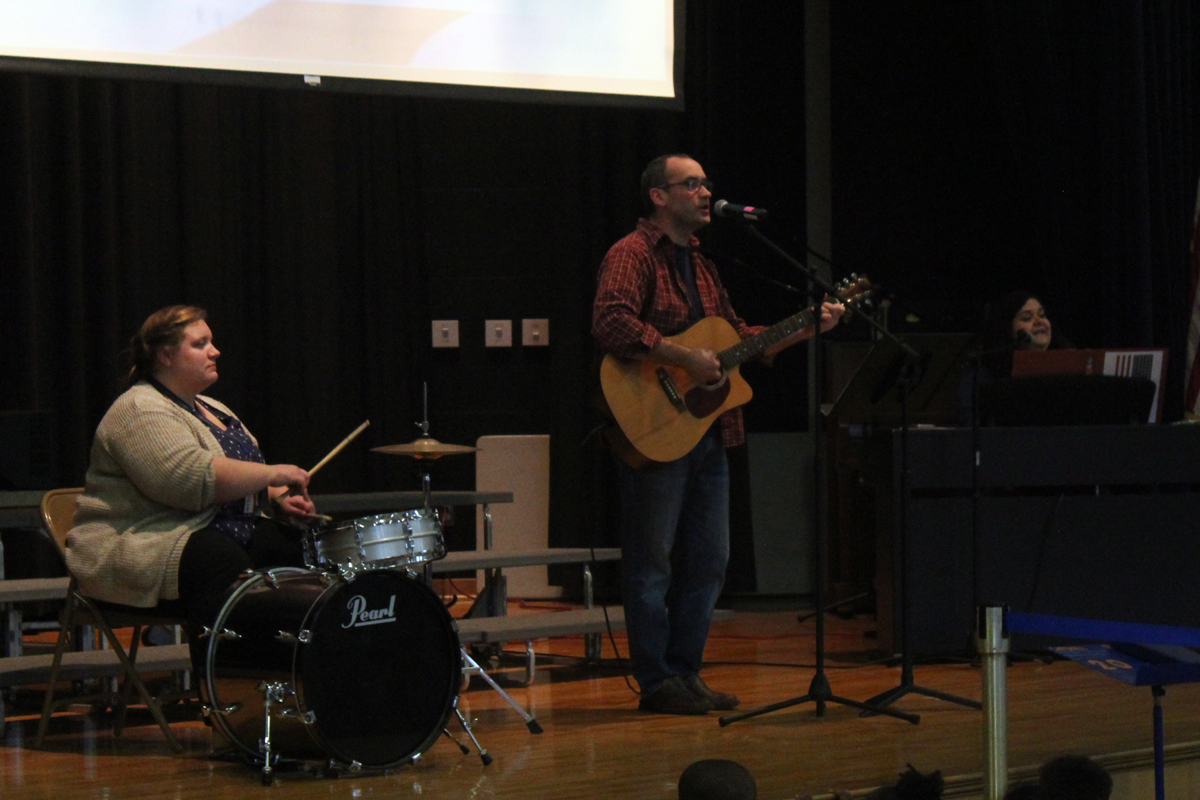 Mr. Thibault on guitar, Mrs. Verdichizzy on piano, and Mrs. Drewello on the drum kit,