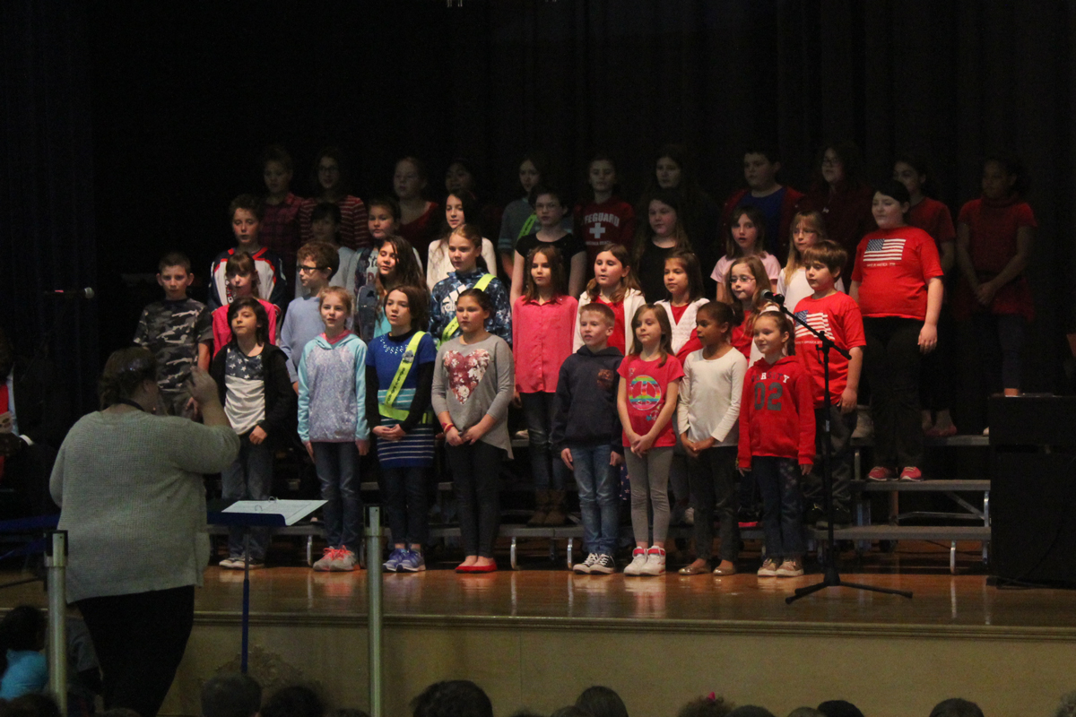 CES Chorus sings on stage