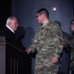 Mr. Schloss shakes hands with his grandson Nathan Bitternman