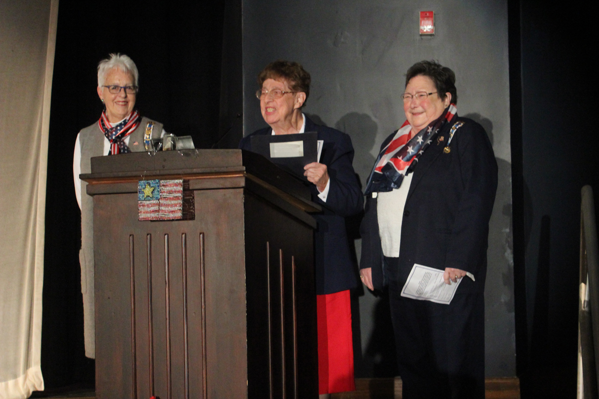 representatives from the Daughters of the American Revolution on stage