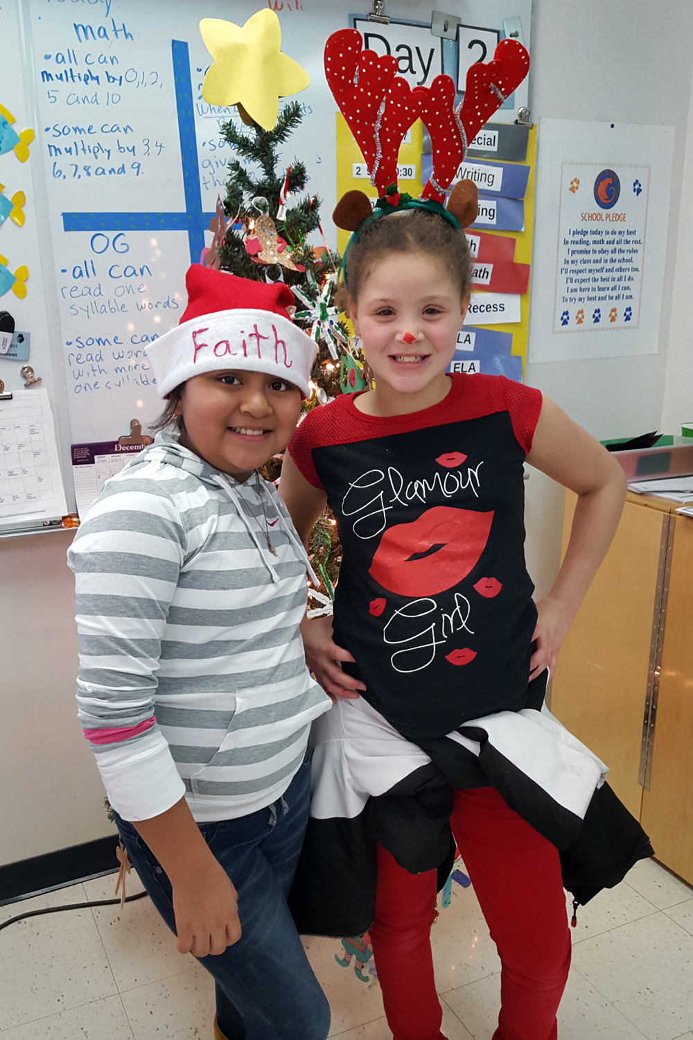 girl with santa hat and girl with antlers