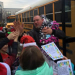 bus driver high-fives students