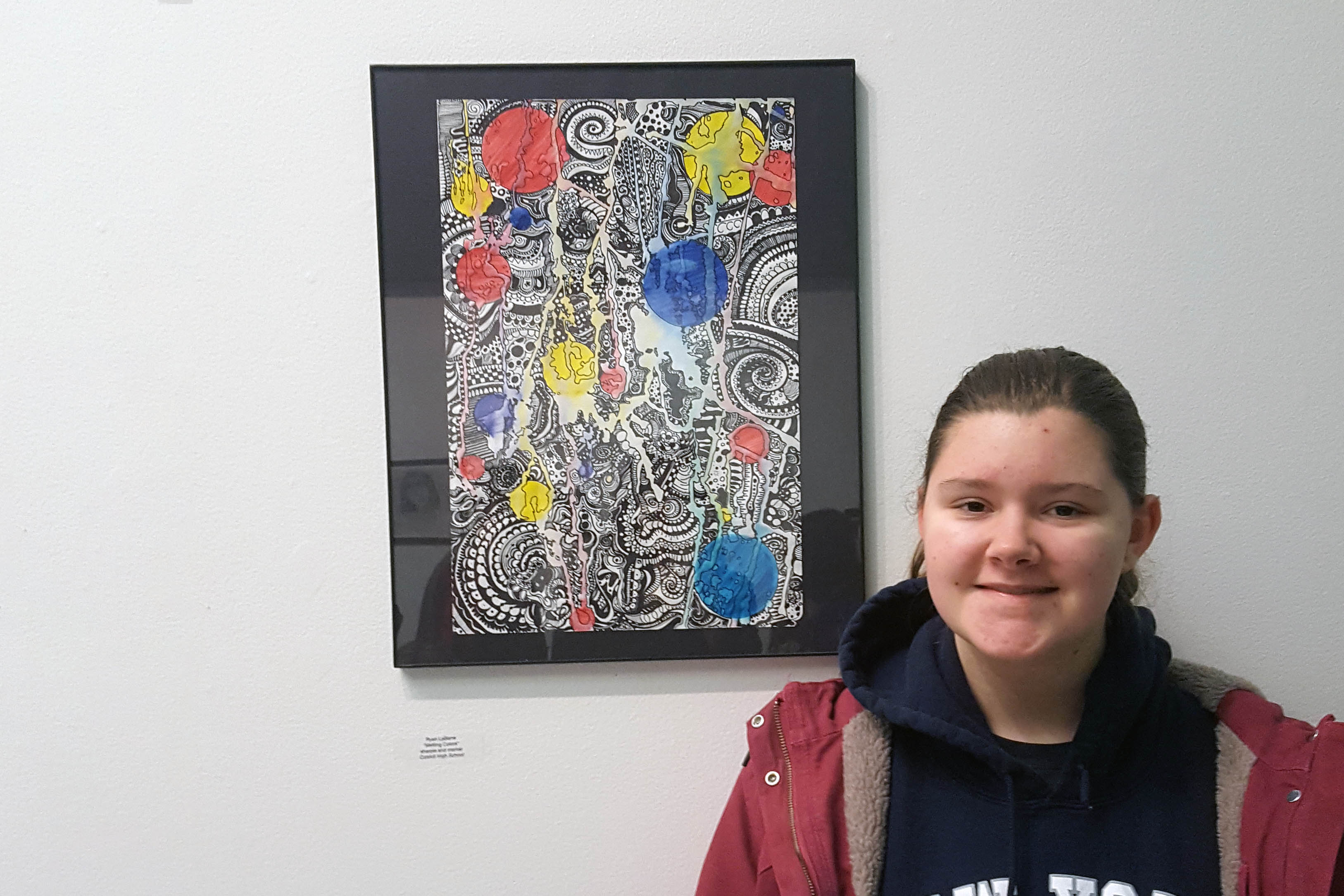 Ryan LaBarre poses with her painting