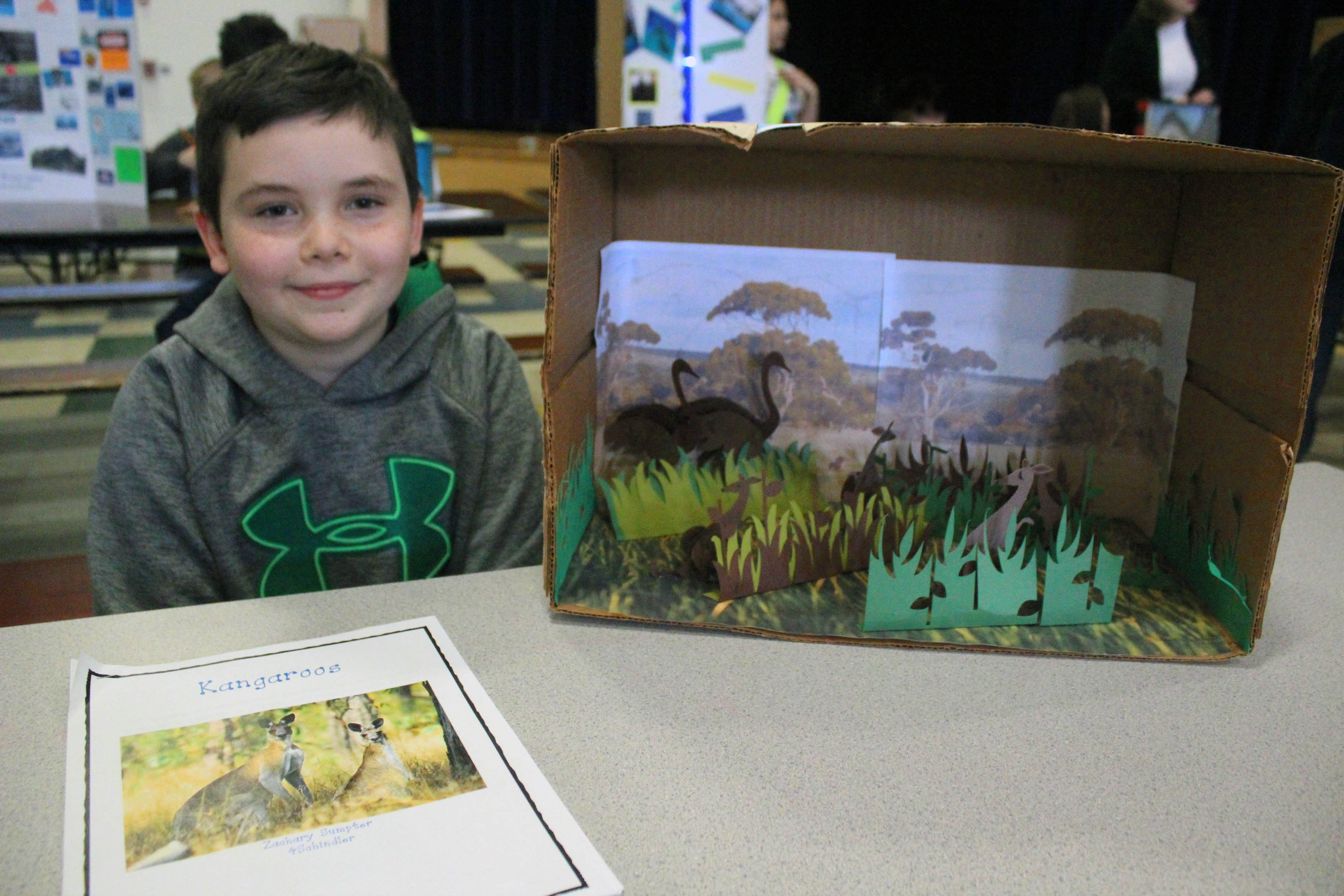 boy poses with diorama