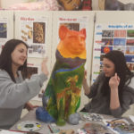 two students painting Cat