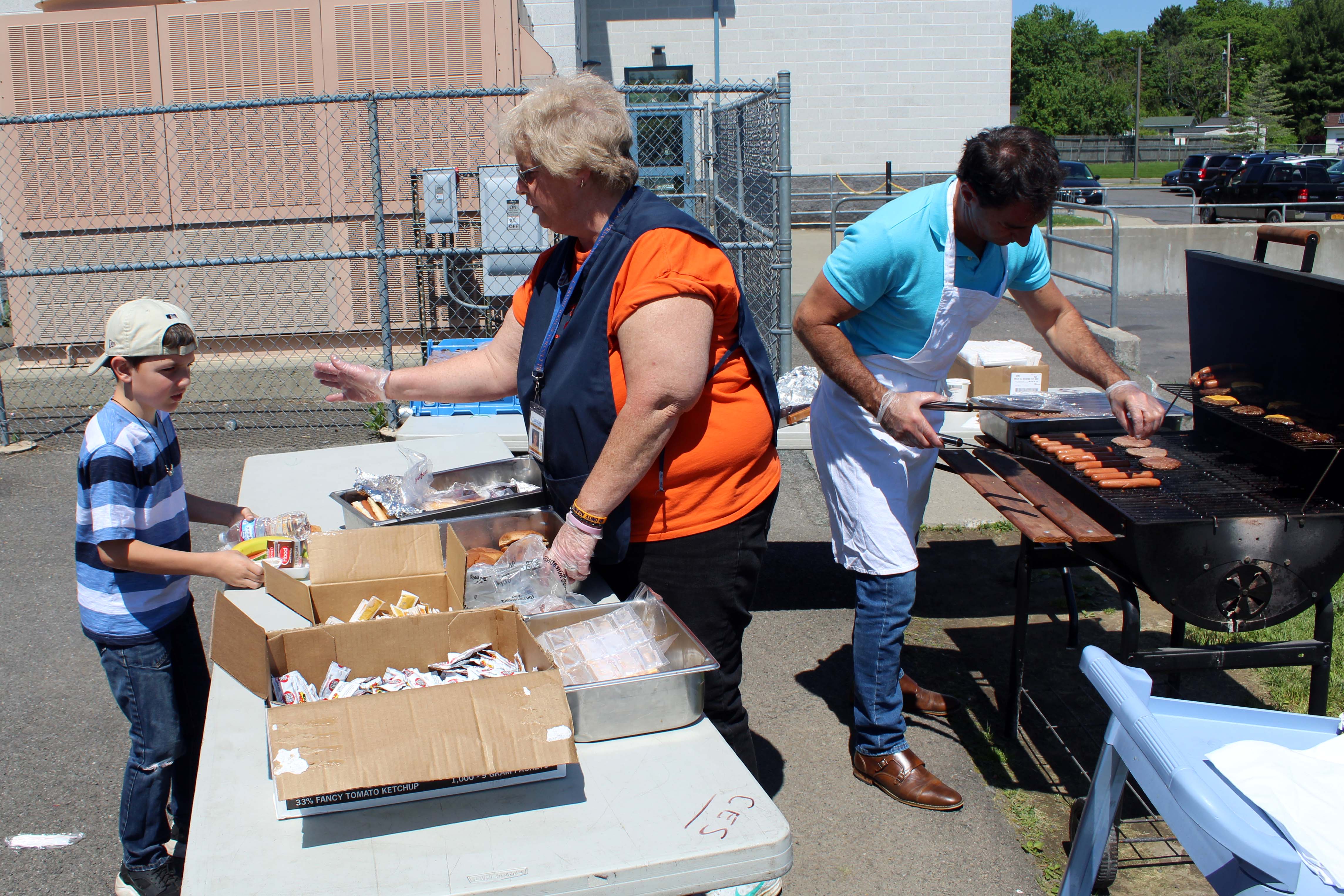 food service workers grilling up lunch