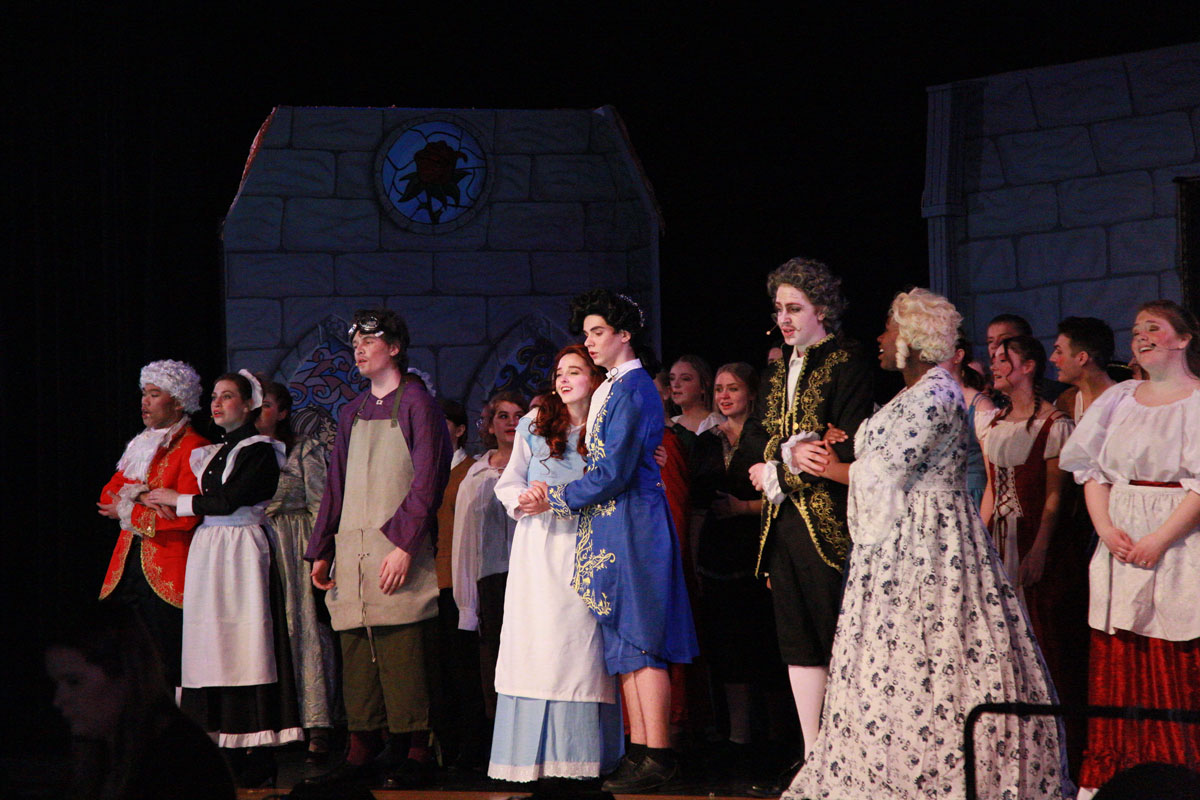 Belle, the prince, the house servants, and townsfolk celebrate