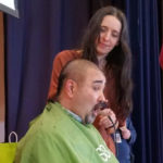Mr. Rivers has his head shaved by