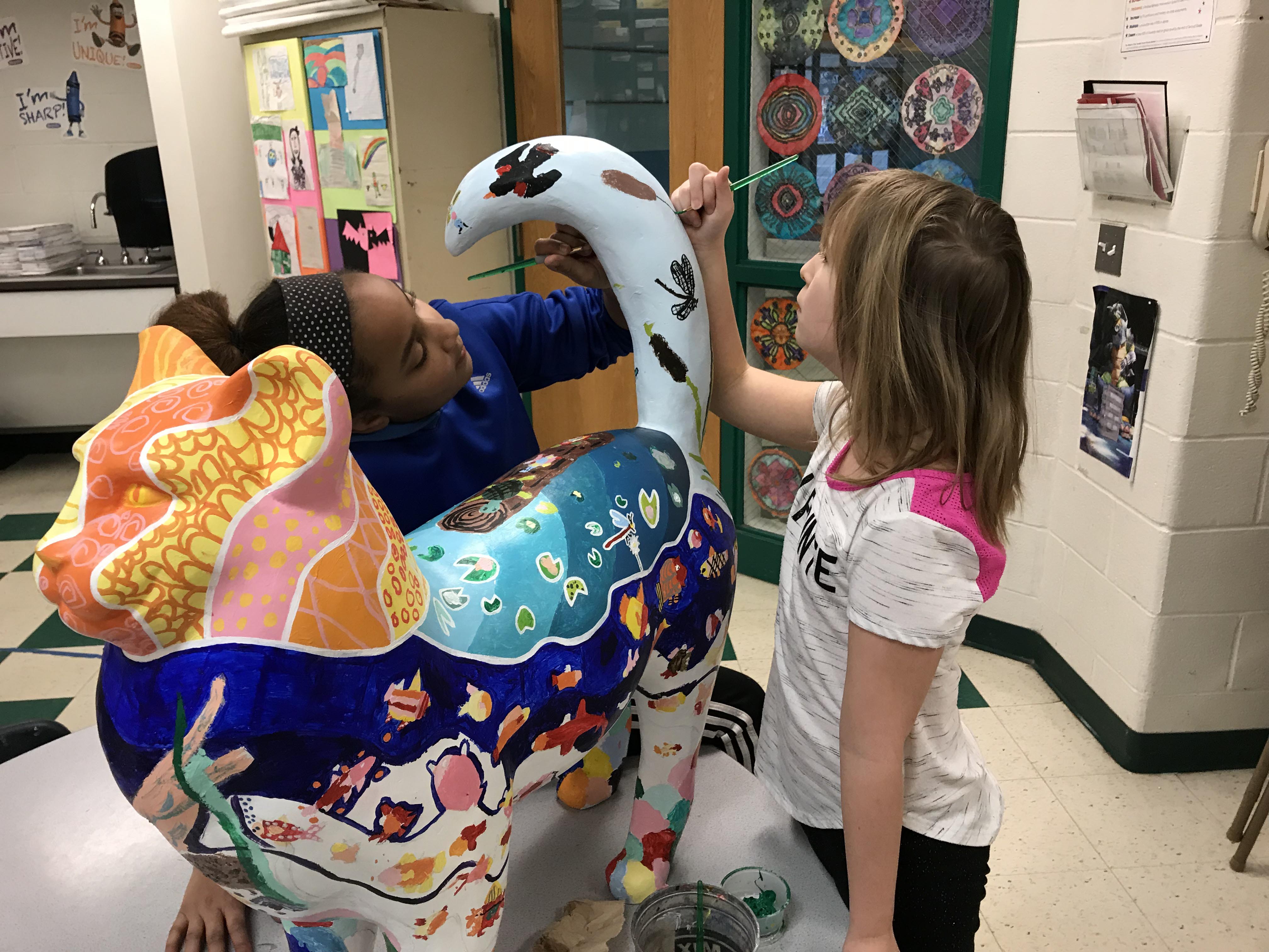 two girls painting cat