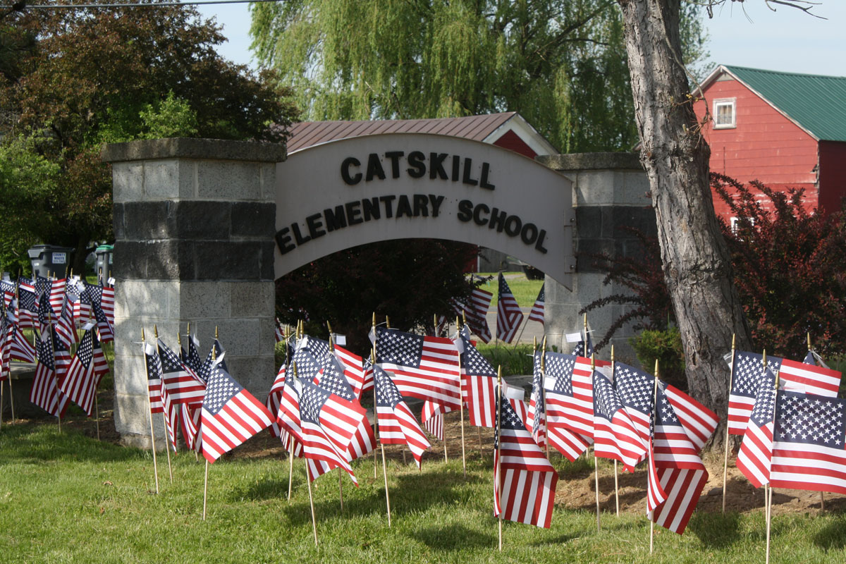 flags on lawn in front of Catskill Elementary School sign