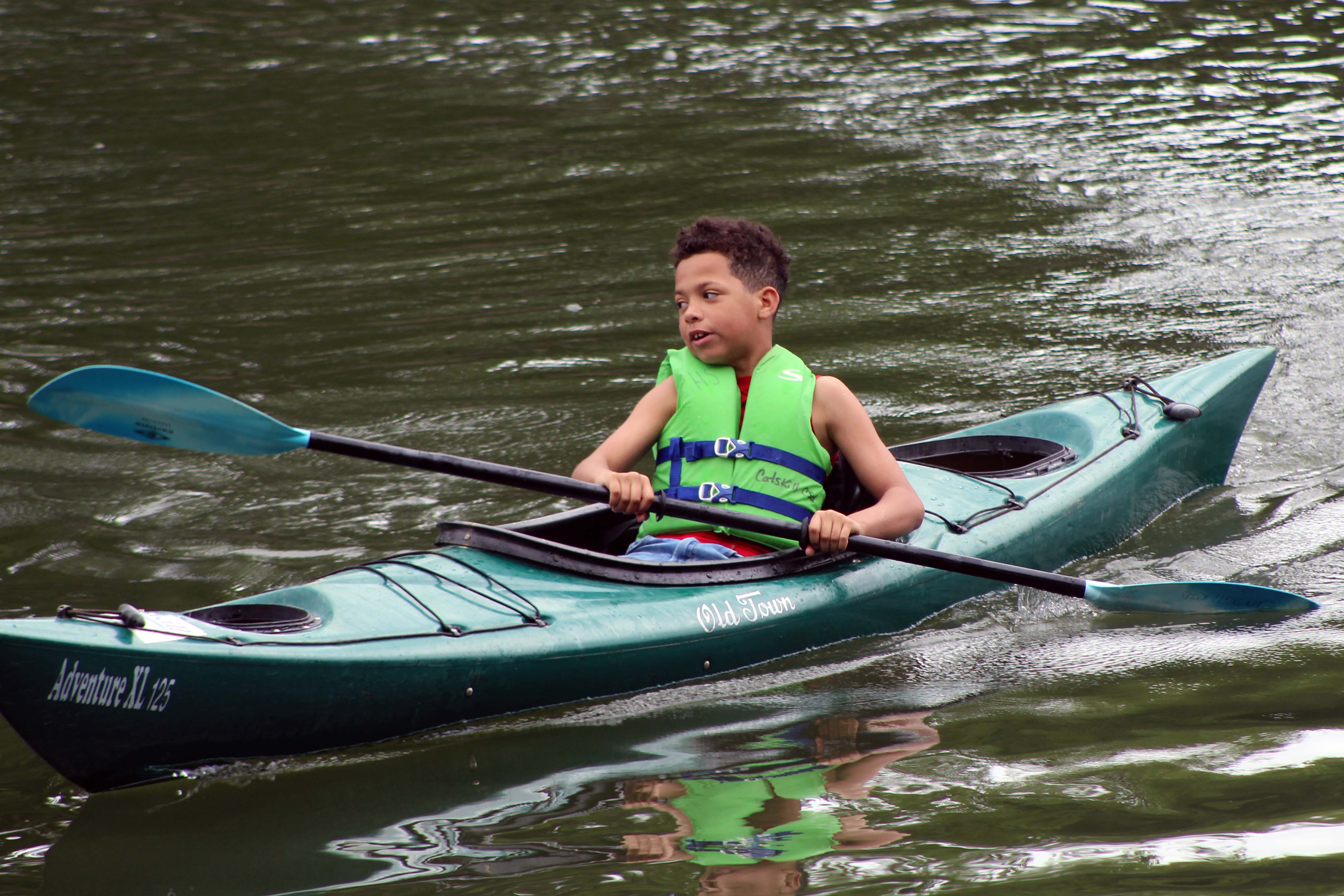 boy paddling kayak