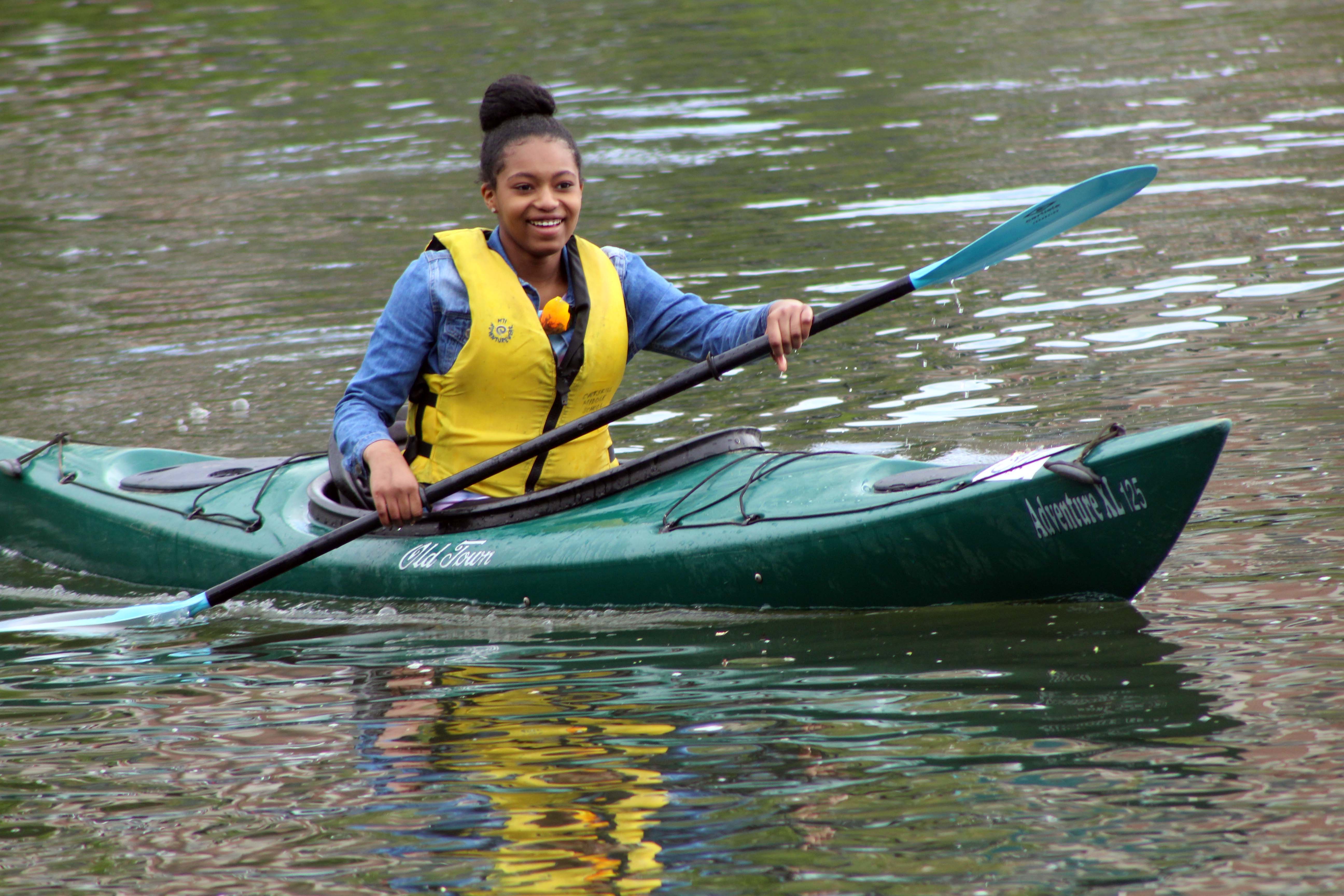 girl paddling kayak