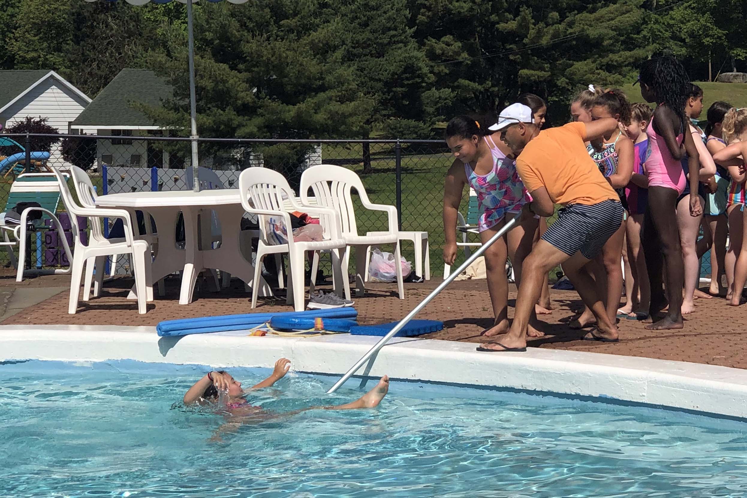 PE Teacher dempstrated how to rescue someone from a pool