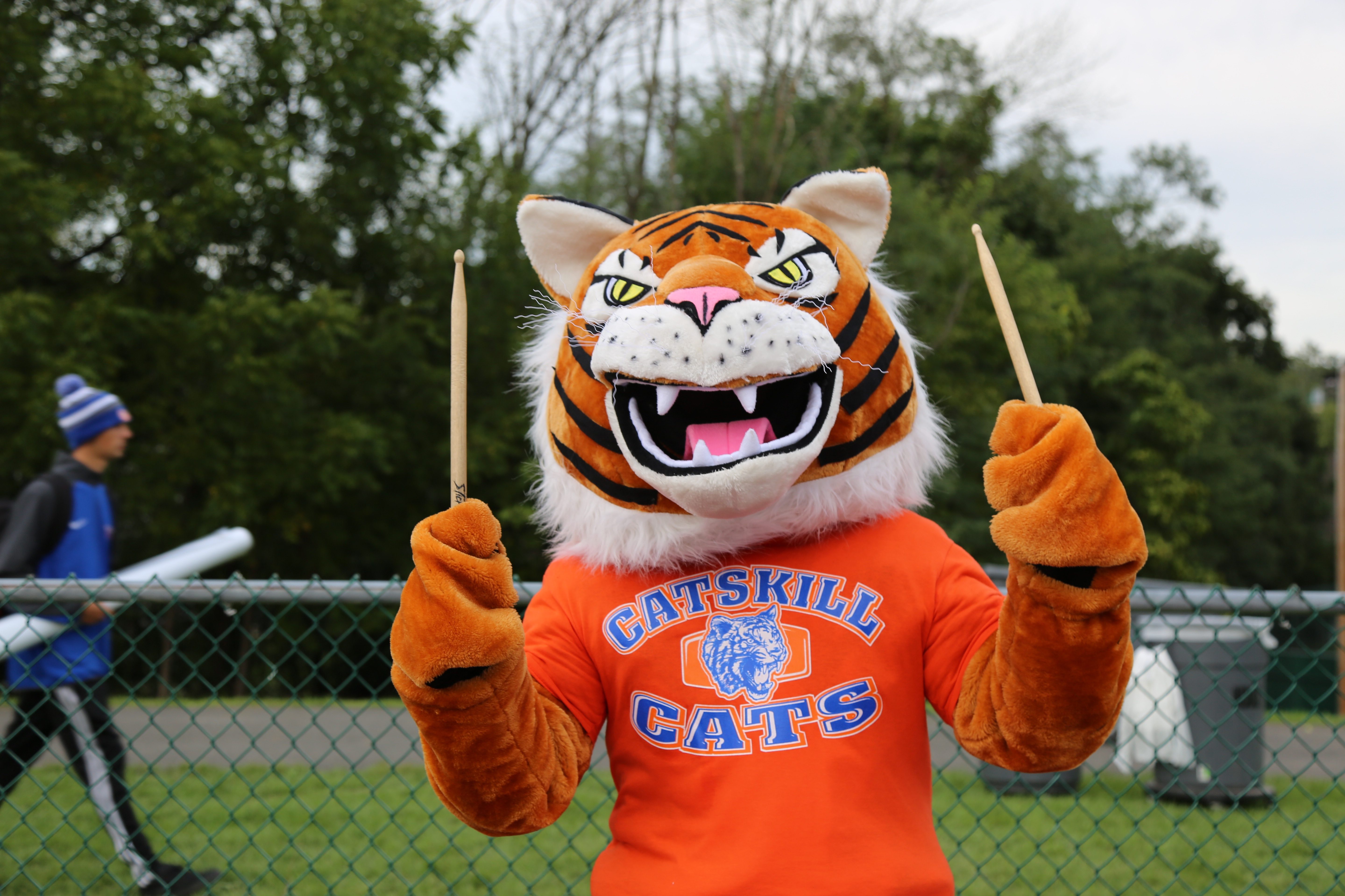 Catskill tiger mascot holding drumsticks