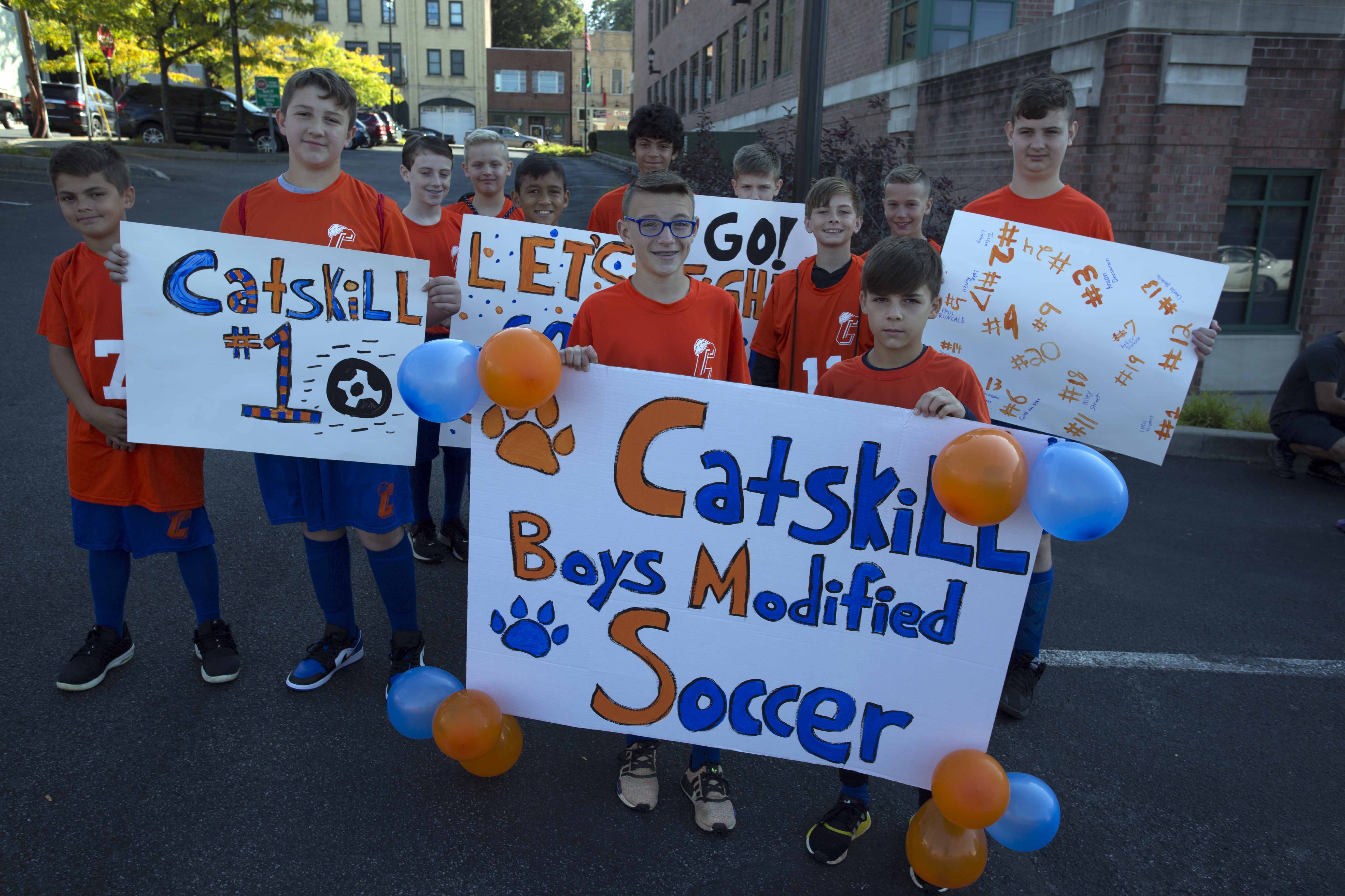 boys modified soccer team holding signs