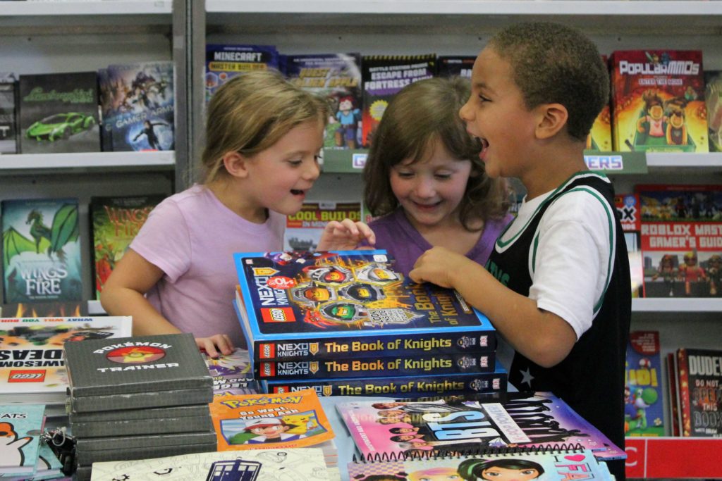 students loking at books and laughing