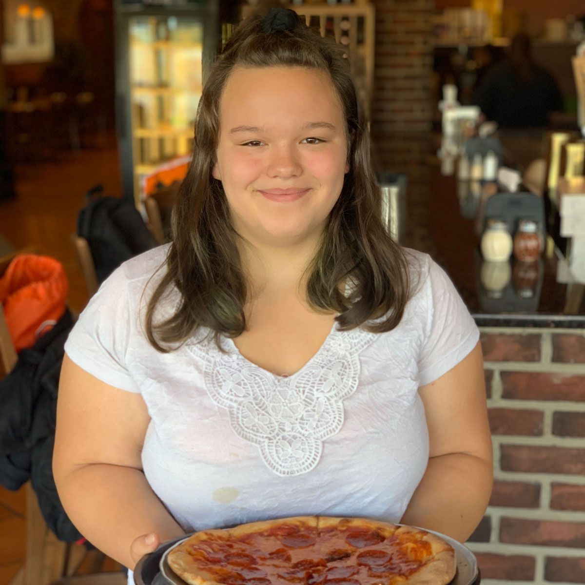girl holding pizza