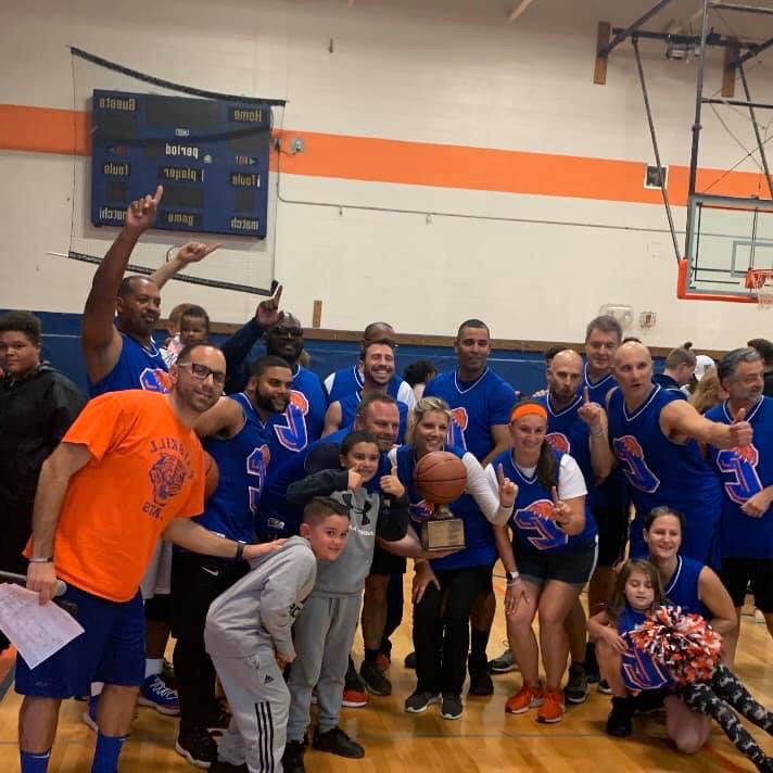 staff basketball team group photo in gym