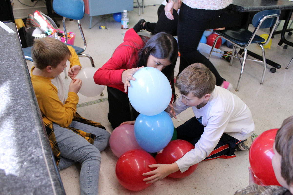 students building balloon tower