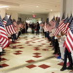 Students holdinf flags in hallway