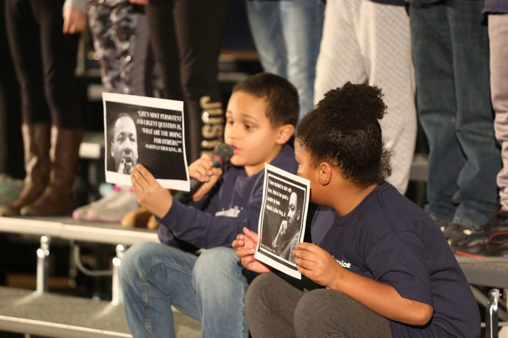 boy reads from flyer while girl looks on