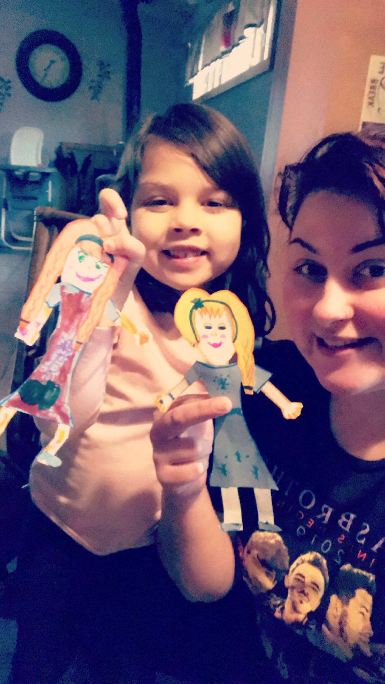 girl and woman holding paper dolls