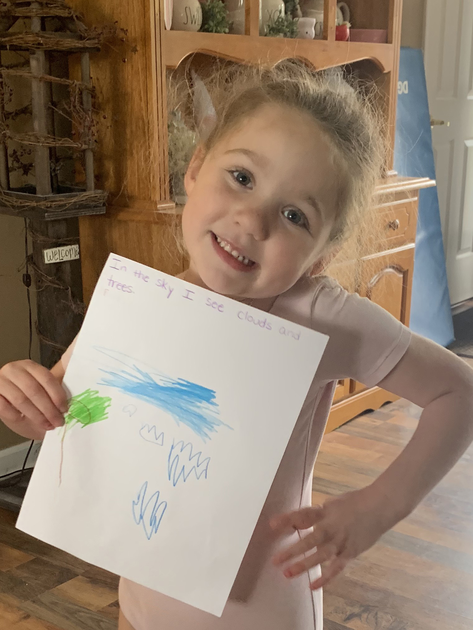 girl holding drawing of sky