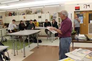Hudson Talbot showing art work to students