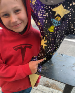 boy pointing to star on cat