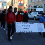 students carrying banner