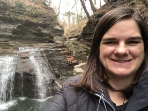 Woman standing in front of waterfall