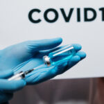 vaccine being held in gloved hands