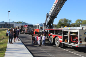 students check out fire truck with ladder up