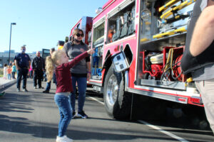 girl pointing to fire truck