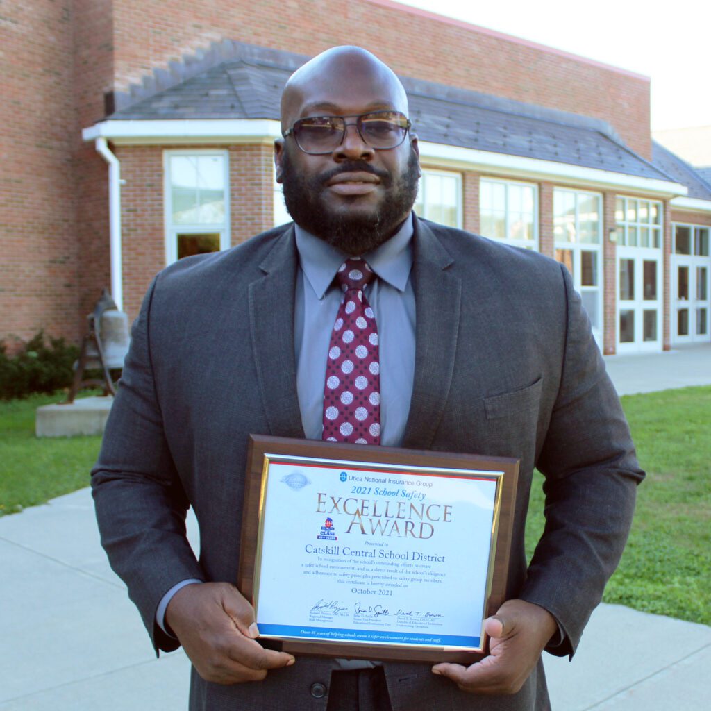 Dr. Ronel Cook holding Safety Excellence Award