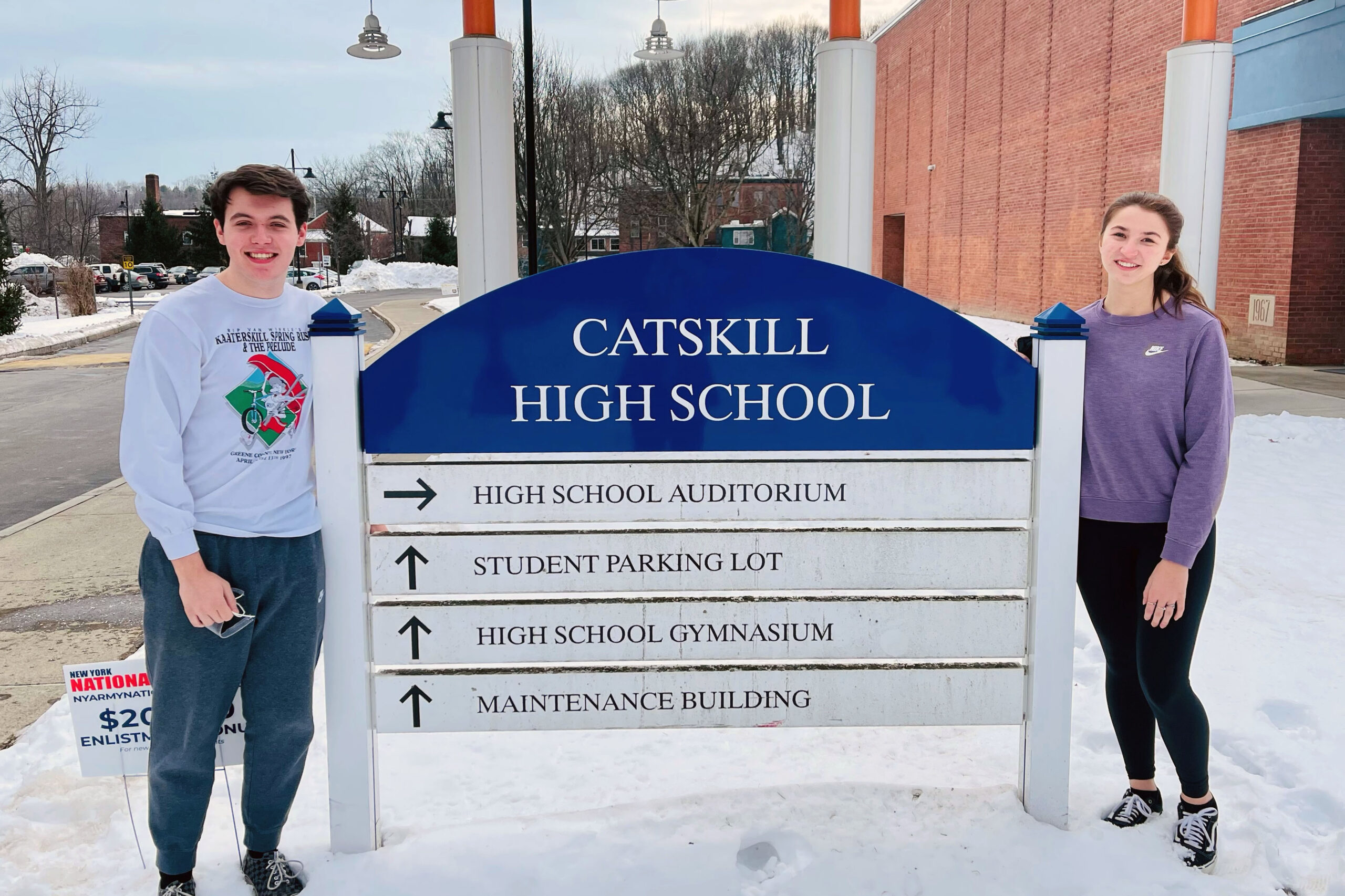 boy and girl pose with Catskill High School Sign