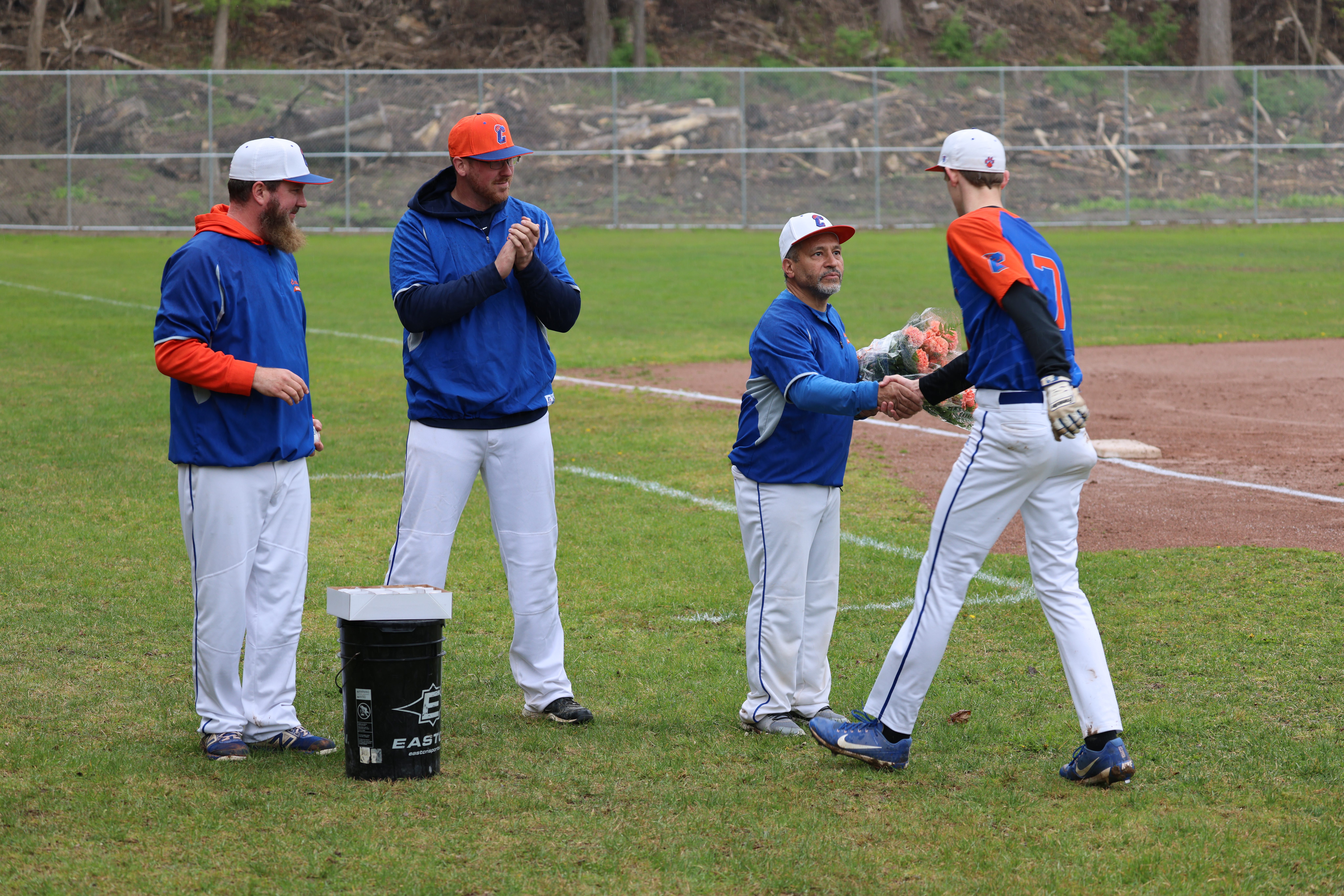 baseball player shakes coach's han